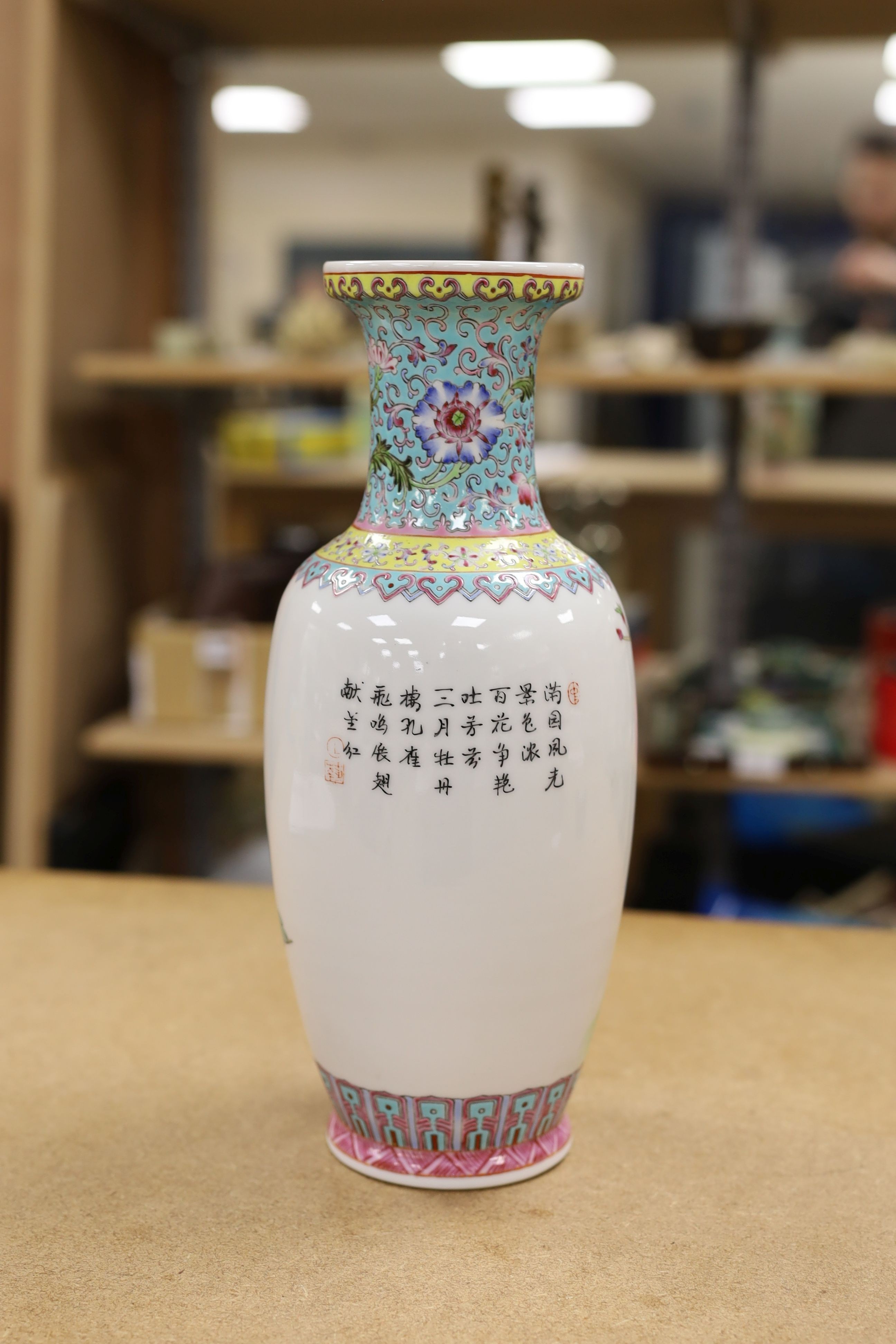 A pair of Chinese famille rose vases decorated with peacocks, 31cm